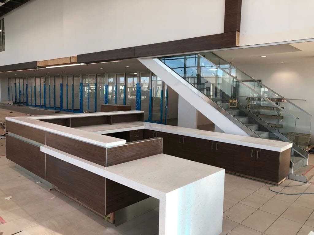 Black Pearl Granite countertop — Customer lounge + reception at Toyota on Regent, Winnipeg