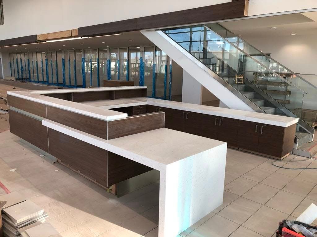 Black Pearl Granite countertop — Customer lounge + reception at Toyota on Regent, Winnipeg
